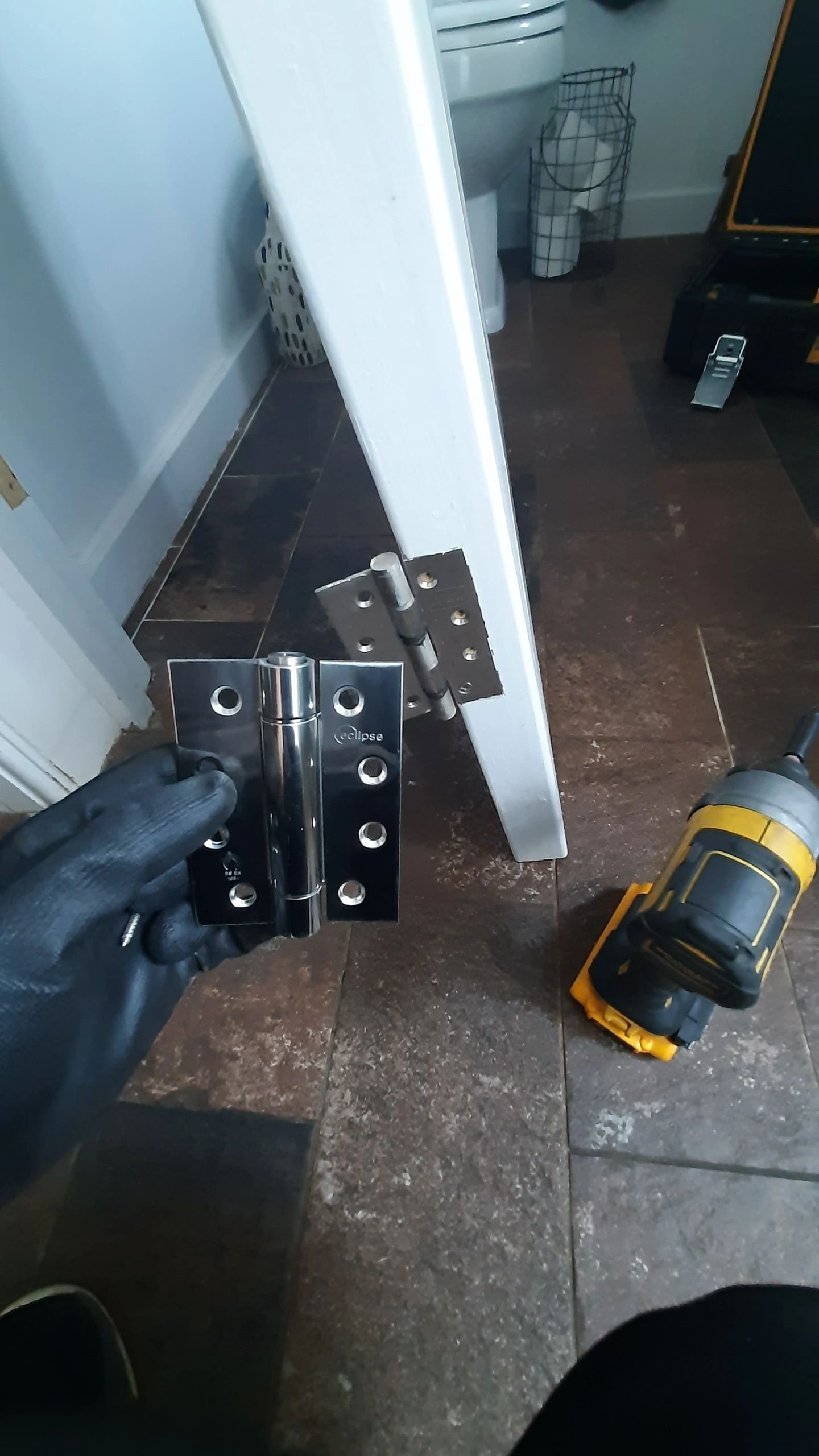 Fire-rated sprung hinges installed on a cloakroom door in Dorking